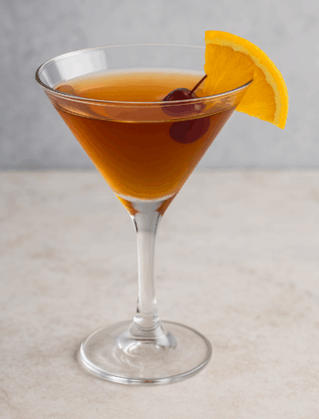 Flapper Cocktail made with rum and French vermouth garnished with cherry and orange slice