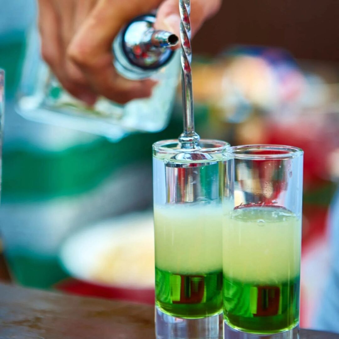 Mixing vibrant green cocktails for customers Cocktails Cocktail Servers CocktailSevers.com
