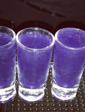 Purple shot glasses on a bar counter. Cocktails, Cocktail Servers, CocktailServers.com