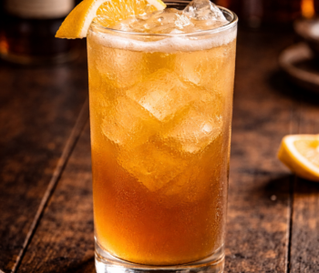 A four horsemen of the apocalypse cocktail recipe served in a highball glass with ice and lemon garnish.