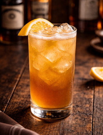 A four horsemen of the apocalypse cocktail recipe served in a highball glass with ice and lemon garnish.