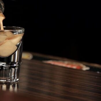 Pouring creamy cocktail into glass shot, Cocktails, Cocktail Servers, CocktailSevers.com