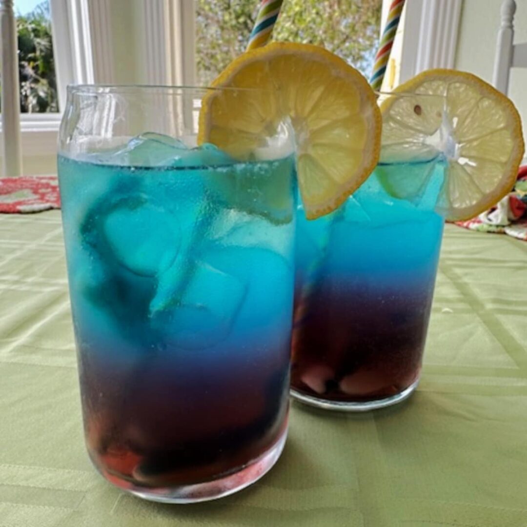 Colorful layered cocktails with lemon garnishes. Cocktails, Cocktail Servers, CocktailSevers.com