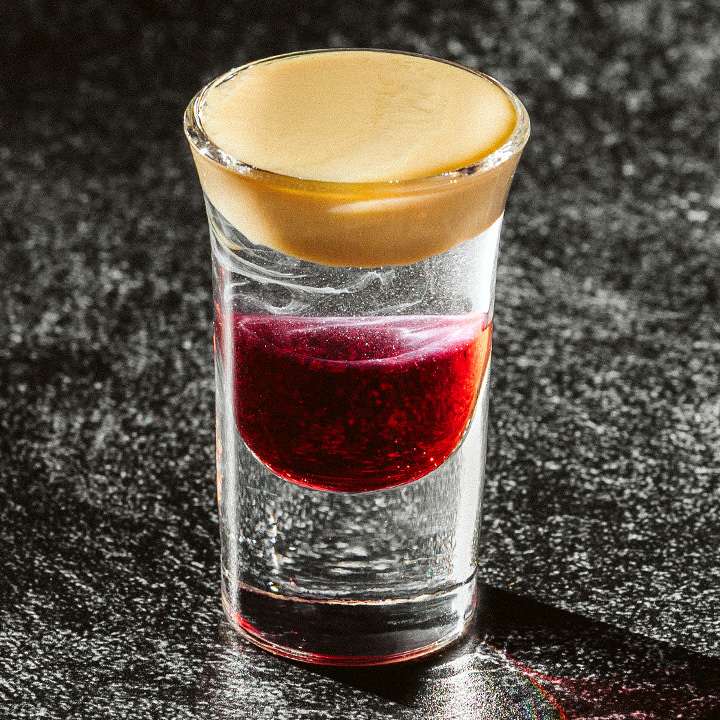 Layered shot cocktail with dark background Cocktails Cocktail Servers CocktailSevers.com