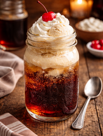 An irish immigrant cocktail recipe served in a mason jar with Vanilla Coke, Irish cream, and vanilla ice cream.